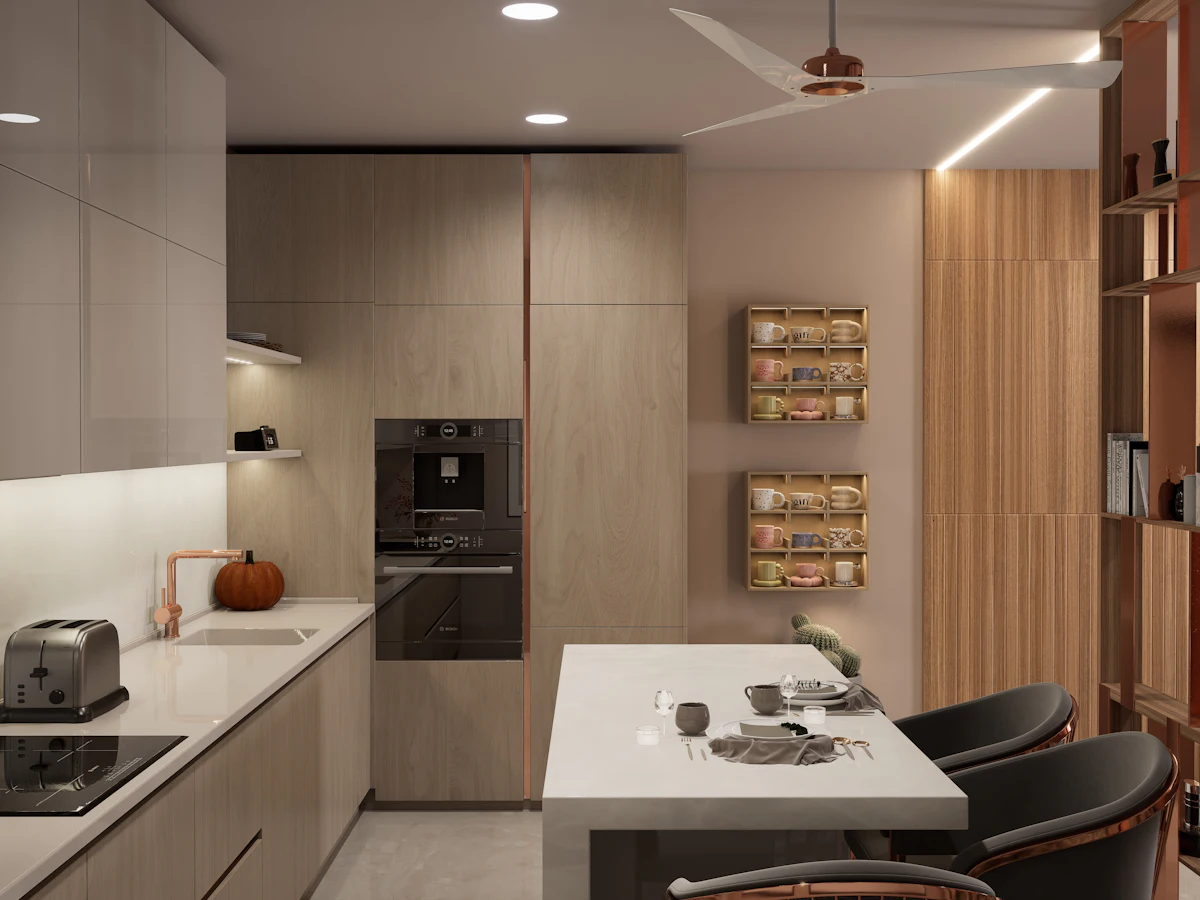 A modern kitchen with light wood cabinets, a built-in oven, a breakfast bar with black chairs and a ceiling fan